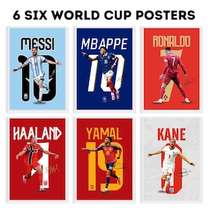 May include: A set of six World Cup posters featuring football players Messi, Mbappe, Ronaldo, Haaland, Yamal, and Kane. Each poster displays the player's name, their jersey number in large font, a full-body action shot, and a printed signature.