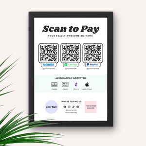 May include: A white sign with black text that reads "Scan to Pay" and "Your Really Awesome Biz Name". The sign has four QR codes for Venmo, Cash App, PayPal, and a generic QR code. Below the QR codes, the sign reads "Also Happily Accepted" and shows icons for cash, card, Zelle, and Apple Pay. The sign also has a logo, social media icons, and a place to put a QR code.