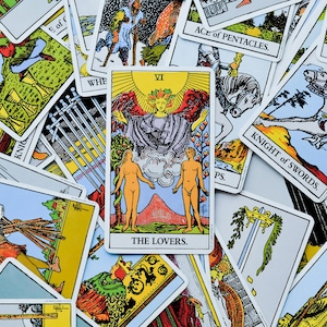 May include: A selection of tarot cards, with the central card labelled "THE LOVERS" depicting two figures and a winged figure. Other cards are visible, including "KNIGHT of SWORDS" and "KING of SWORDS."