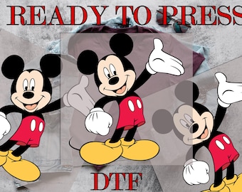 May include: Three digital cut files of Mickey Mouse in a red and black color scheme. The text "READY TO PRESS" and "DTG" are also included in the image.