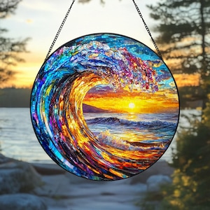 May include: A stained glass window hanging with a colorful depiction of a large wave crashing over a sunset. The wave is made of many small pieces of glass in shades of blue, purple, and yellow. The sunset is a vibrant orange and yellow.