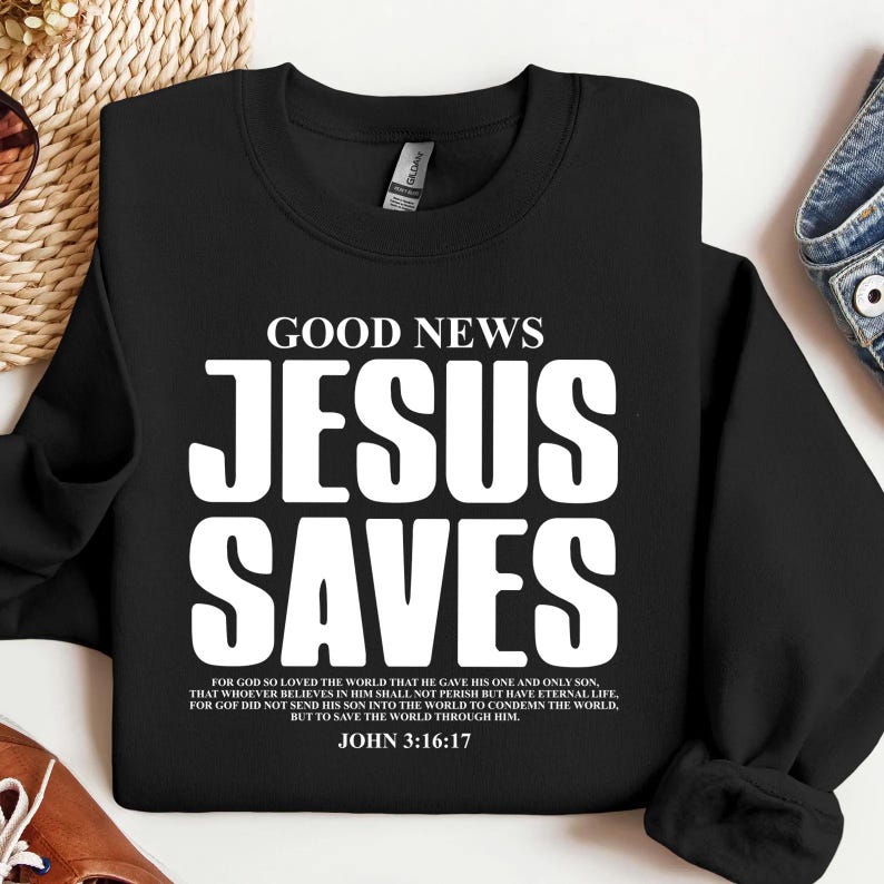 May include: Black sweatshirt with white text that reads "GOOD NEWS JESUS SAVES" and a Bible verse from John 3:16-17.
