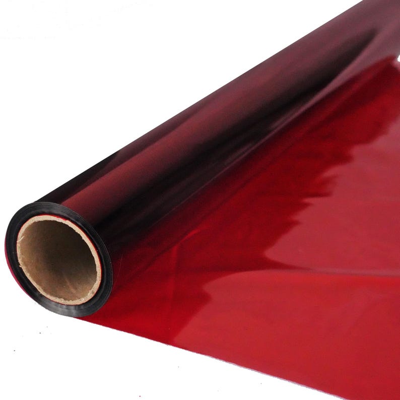 May include: A roll of red iridescent wrapping paper with a black core.