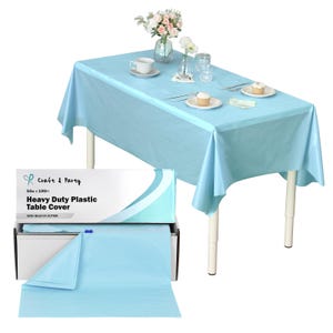 May include: A light blue heavy-duty plastic table cover, displayed on a table set for a gathering. The table is set with plates, cupcakes, and flowers. A box of the table cover is also shown, with the text "Craft & Party" and "54in x 100ft".