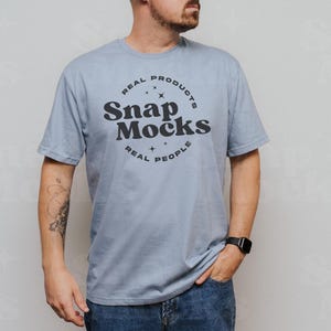 May include: A light blue t-shirt with a black circle logo that says "Real Products Snap Mocks Real People".