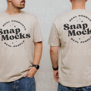 May include: A beige t-shirt with a black circle graphic that says "Real Products Snap Mocks Real People".