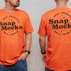 May include: Orange t-shirt with a black circle graphic on the front and back. The graphic says "REAL PRODUCTS Snap Mocks REAL PEOPLE".