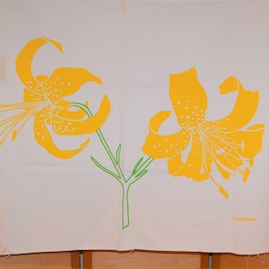May include: A white fabric panel featuring two yellow lilies printed on it. The lilies have green stems and leaves. The fabric has the word "MARUSHIMA" printed in the bottom right corner.