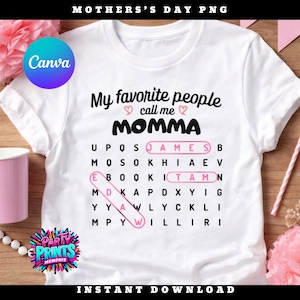 May include: White t-shirt with the text "My favorite people call me MOMMA" in black script. A word search puzzle highlights the names JAMES, EBOOK, and TAMN in pink. The shirt has a Canva logo and "Party Prints Memphis" logo.