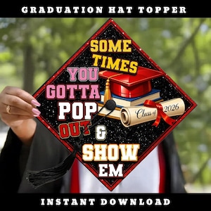 May include: A diamond-shaped graduation hat topper with a black starry background. It features the text "SOMETIMES YOU GOTTA POP OUT & SHOW EM" in yellow and pink, a red graduation cap on books, and a diploma scroll labelled "Class of 2026".