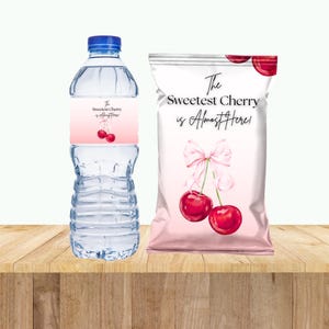 May include: A pink and white party favor bag with a cherry design and the text "The Sweetest Cherry is Almost Here!"  A clear plastic water bottle with a pink and white label that says "The Sweetest Cherry is Almost Here!"