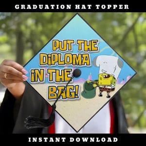 May include: A square graduation hat topper featuring a light blue and sandy background with the text "PUT THE DIPLOMA IN THE BAG!" and a graphic of a yellow sponge character wearing a white hat and holding a green bag, with a black tassel attached.