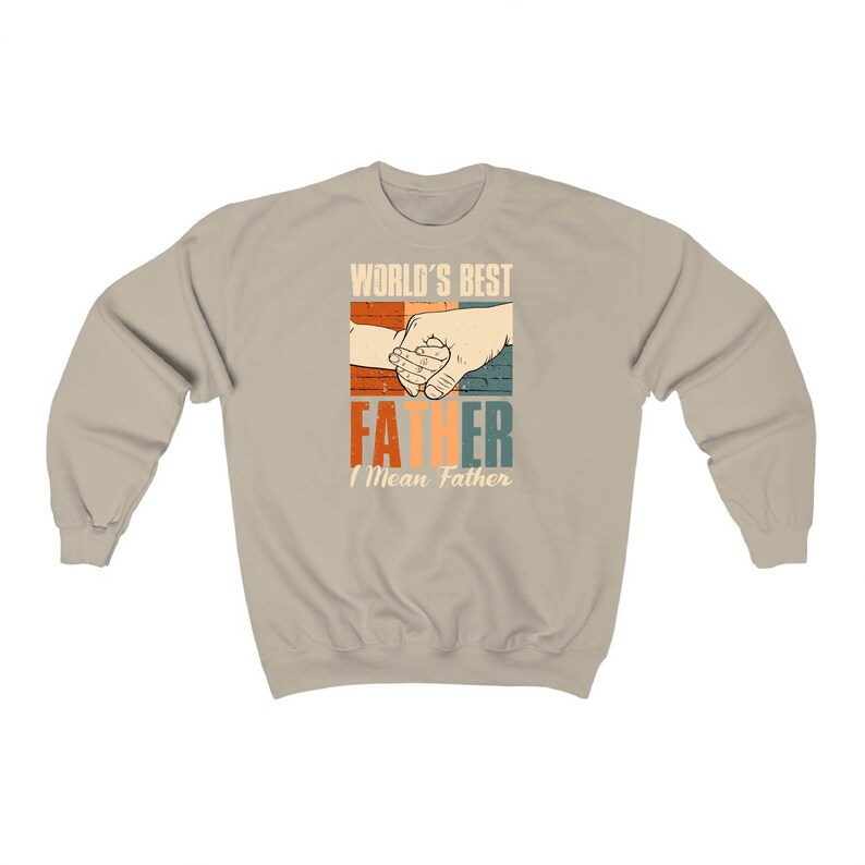 May include: A tan sweatshirt with a retro-style graphic that says "World's Best Father I Mean Father" with a picture of two hands holding each other.