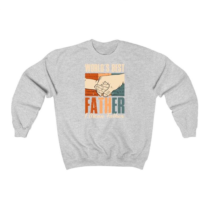 May include: Gray sweatshirt with a retro-style graphic that says "World's Best Father" with a hand holding a smaller hand. The text "I Mean Father" is below the graphic.