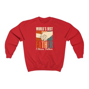 May include: Red sweatshirt with a retro-style graphic that says "World's Best Father I Mean Father" with two hands holding each other.