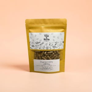May include: A brown paper bag with a clear window displaying brown capsules. The bag has two white labels with text and botanical illustrations. The top label reads "Vita Herbs". The bottom label says "Organic Celery 1000mg".