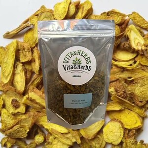 May include: A transparent bag of dried herbs, labelled "Vita & Herbs" and "Organic", surrounded by dried, yellow-orange root vegetable slices. The label also states "Shilajit Root". The image is set against a white background.