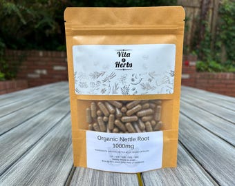 May include: A brown paper bag with a white label that says "Vita & Herbs" and "Organic Nettle Root 1000mg". The bag contains brown capsules.