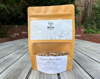 May include: A brown paper bag with a white label that says "Vita & Herbs" and "Organic Black Maca 1000mg". The bag contains a clear plastic bag filled with brown capsules.