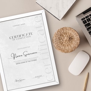 May include: A white framed certificate of completion with a gray textured background. The text reads "Certificate of Completion" and "This is to certify that Name Surname has successfully completed a training course and qualified in the professional application of ENTER NAME OF THE COURSE." The certificate is signed "Nome Surname" and dated "20.01.2025".