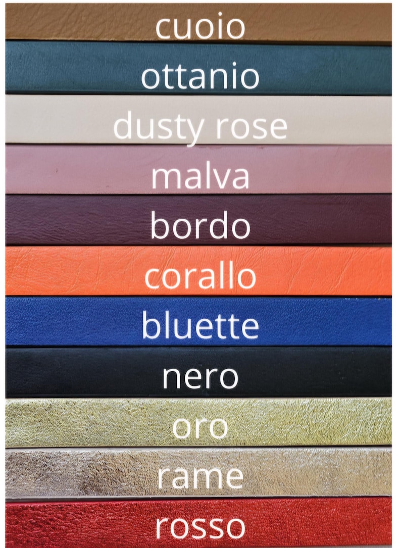 May include: A color chart with 11 leather swatches, each labeled with an Italian word for a color. The colors are: cuoio (brown), ottanio (teal), dusty rose (pink), malva (purple), bordo (burgundy), corallo (orange), bluette (blue), nero (black), oro (gold), rame (copper), and rosso (red).