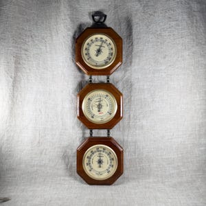 May include: A white ceramic mug with a black handle and the text "But First, Coffee" in a black, bold font. The mug is on a white surface.