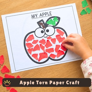 Op de afbeelding: Een wit vel papier met een zwarte omtrek van een appel en de tekst MY APPLE bovenaan. De appel is gevuld met kleine, onregelmatige stukjes rood papier, terwijl het blaadje groen is en het steeltje bruin is ingevuld.