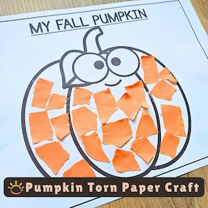 May include: A white paper sheet featuring a black outline of a pumpkin with the text MY FALL PUMPKIN at the top. The pumpkin is partially filled with small, irregular pieces of orange paper glued onto the surface to create a collage effect.
