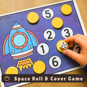 May include: A space-themed roll and cover game board featuring a blue rocket ship illustration on a purple starry background. The board includes white circles with black numbers 1 through 6, yellow circular tokens, and a white six-sided die.