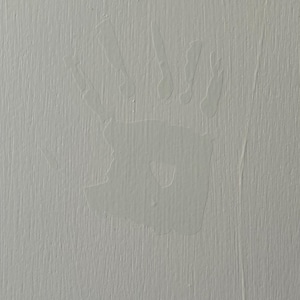 May include: A white handprint on a light gray textured surface.