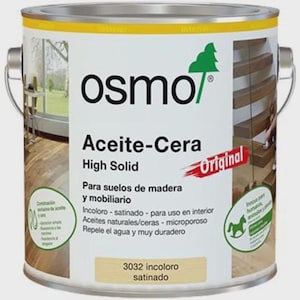 Può includere: Un barattolo di vernice metallico con un'etichetta bianca con il marchio "osmo" e i dettagli del prodotto. L'etichetta include testo in spagnolo, come "Aceite-Cera" e "High Solid". Il barattolo ha un manico argentato e un bordo giallo.