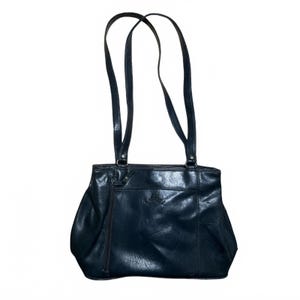 May include: A dark navy blue shoulder bag with a smooth, slightly glossy finish. The bag features two long, thin shoulder straps, a horizontal zippered pocket across the upper front, and a vertical zippered pocket on the left side of the front panel.