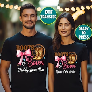 May include: Two black t-shirts featuring a graphic design with a pink bow, brown cowboy boots, and a wagon wheel. The text reads Boots or Bows, with Daddy Loves You on one shirt and Keeper of the Gender on the other. Includes DTF Transfer Ready to Press text.