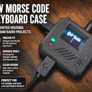 May include: Black CW Morse Code Keyboard Case with a small screen displaying data. The case is 3D printed and designed for Ham radio projects. The text on the case reads "CW Morse Code Keyboard Case" and "3D Printed Housing for Ham Radio Projects."
