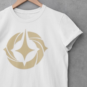 Shirt geïnspireerd op Lorcana | T-shirt uniseks gouden symbool | T-shirt met ruilkaartspel | T-shirt met grafische print | Gamercadeau