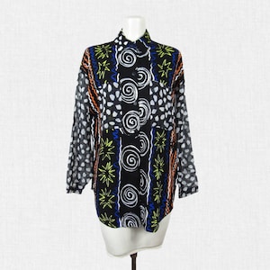 May include: A black and white long-sleeved button-up shirt with a colorful abstract print featuring swirls, stars, and dots.