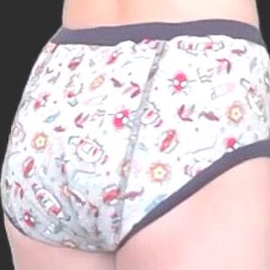 May include: White underwear featuring a repeating pattern of red and black cartoon insects and flowers. The waist and leg openings are trimmed with grey. The background is a dark grey.