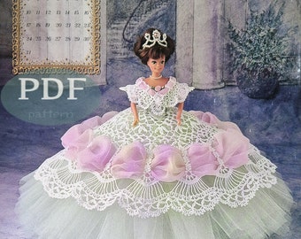 May include: A crochet doll dress pattern for a doll wearing a green and white dress with pink bows and a crown. The pattern is titled "Miss August 1997" and is an Annie Potter Original.