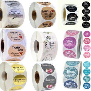 May include: Several rolls of stickers with 'Thank you' messages. Designs vary, including floral patterns, bows, and different fonts. Some stickers say 'Thank you for your order!' or 'Thank you for your business'.