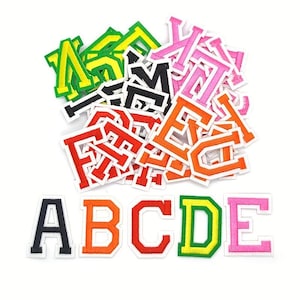 May include: A selection of colourful embroidered letter patches in various shades, including black, orange, red, green, and pink. The letters A, B, C, D, and E are arranged at the bottom. The patches have a white border, perfect for customising clothing.