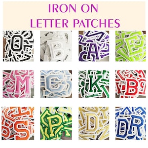 May include: A selection of iron-on letter patches in diverse colours and fonts. The image shows individual letters, including O, B, A, E, M, G, K, B, S, P, D, and DR. The patches have a white border and are for fabric customisation.
