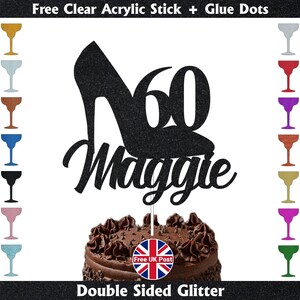 May include: A black glitter cake topper featuring a high heel, the number 60, and the name "Maggie". The topper is placed on a chocolate cake. The text "Free Clear Acrylic Stick + Glue Dots" and "Double Sided Glitter" are also visible.