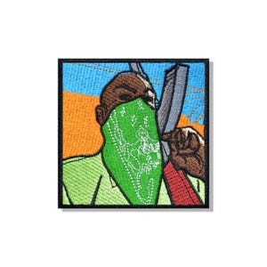 May include: A square embroidered patch featuring a stylised figure wearing a bright green bandana over their face. The figure is depicted against a background of orange and blue, holding a grey object. The embroidery uses vibrant thread colours.