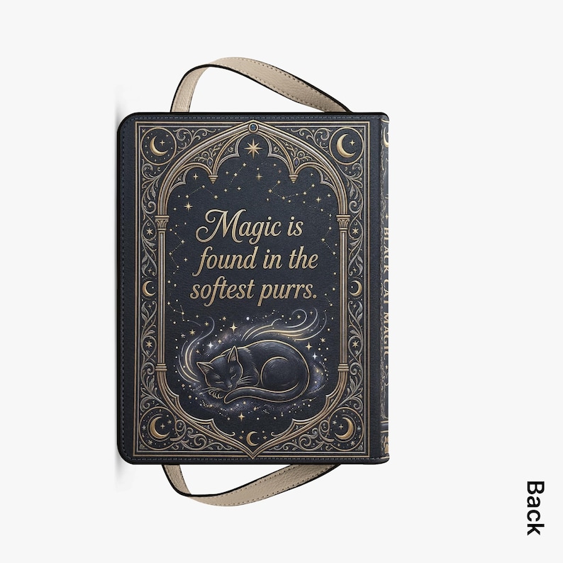 May include: A black book-style bag with a cream-colored handle. The cover features a sleeping black cat illustration with the text "Magic is found in the softest purrs." Ornate gold-colored embellishments frame the text and cat.