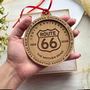 Route 66 100th Anniversary Wooden Ornament
Celebrate a century of the "Mother Road" with this intricately laser-engraved wooden ornament. Commemorating the 100th Anniversary (1926–2026), this piece features the iconic Route 66 shield at its center, surrounded by a tribute to the legendary highway that defined American travel.