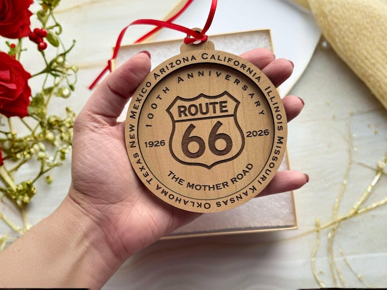 Route 66 100th Anniversary Wooden Ornament
Celebrate a century of the "Mother Road" with this intricately laser-engraved wooden ornament. Commemorating the 100th Anniversary (1926–2026), this piece features the iconic Route 66 shield at its center, surrounded by a tribute to the legendary highway that defined American travel.