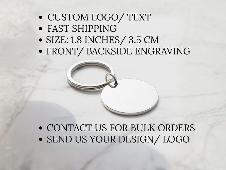 May include: A silver-colored, blank oval keychain with a ring. The keychain is 1.8 inches (3.5 cm) in size and can be engraved on the front and back. The image also includes text about custom logos and bulk orders.