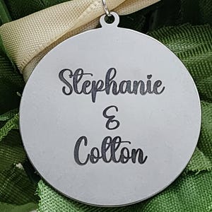 "On silver round pendant names engraved for homecoming 2025"