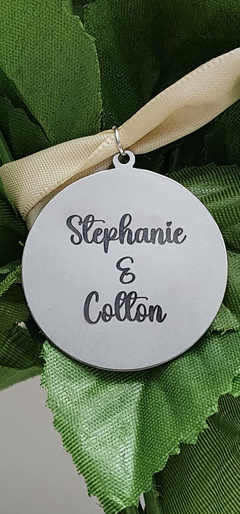 "On silver round pendant names engraved for homecoming 2025"