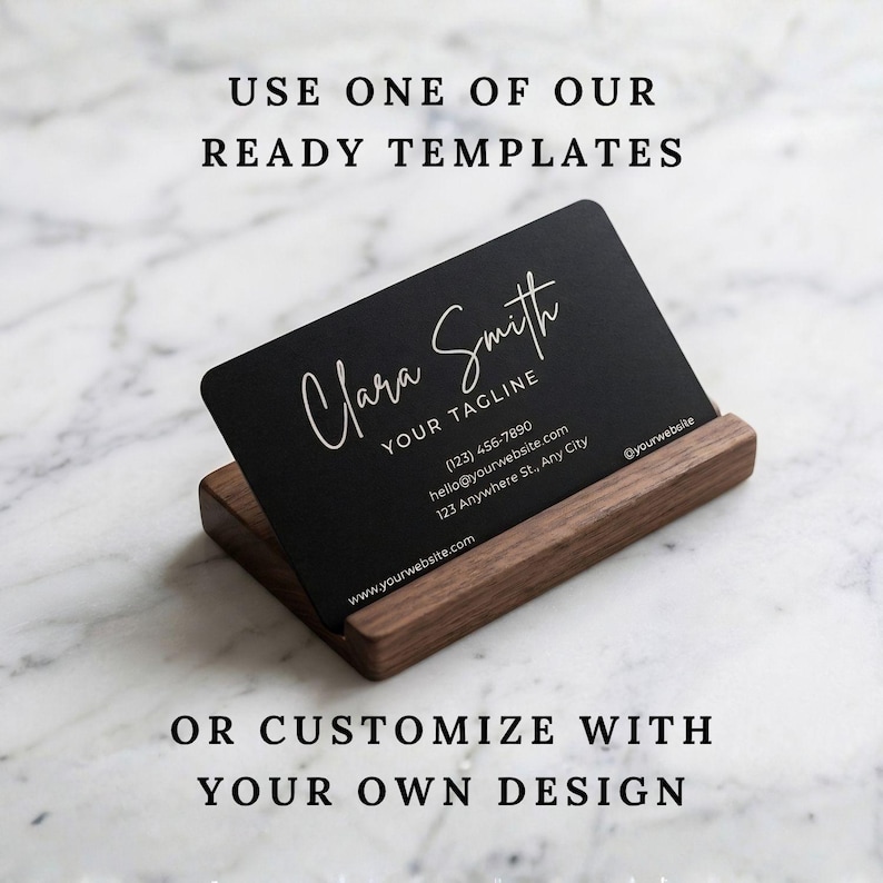 Custom engraved metal business card displayed in a wooden holder with option to use a template or upload your own design.